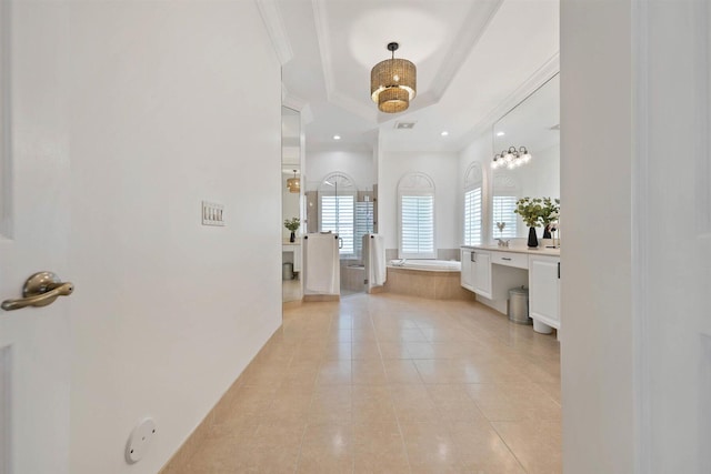 bathroom with vanity, crown molding, tile patterned floors, and tiled tub