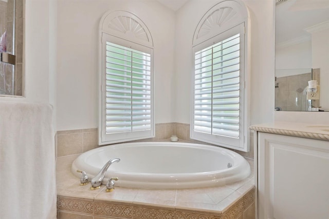 bathroom featuring vanity, a healthy amount of sunlight, ornamental molding, and shower with separate bathtub