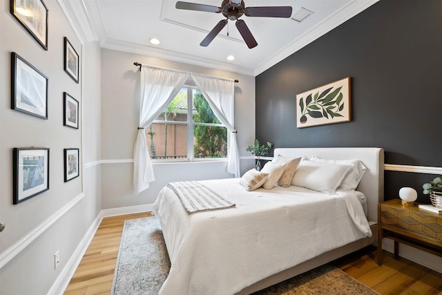 bedroom with crown molding, hardwood / wood-style floors, and ceiling fan