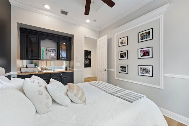 bedroom with ornamental molding, light hardwood / wood-style flooring, and ceiling fan