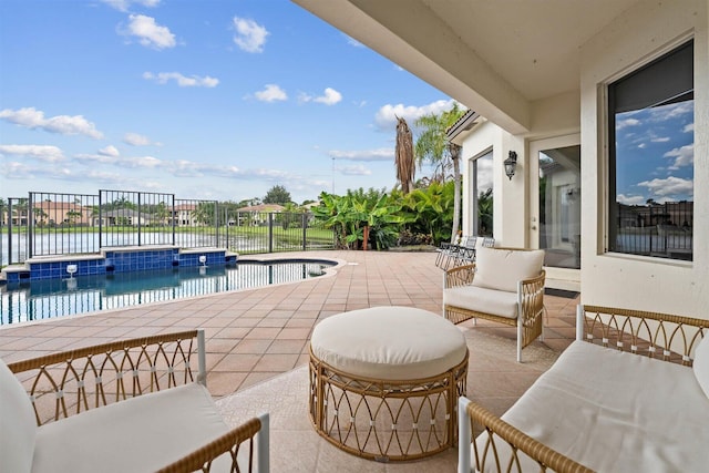 view of patio / terrace with a fenced in pool and a water view