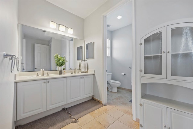 bathroom featuring toilet, vanity, and tile patterned floors