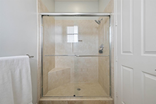 bathroom with a shower with shower door