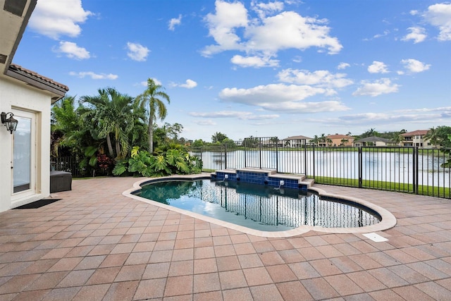 view of pool with a water view and a patio area