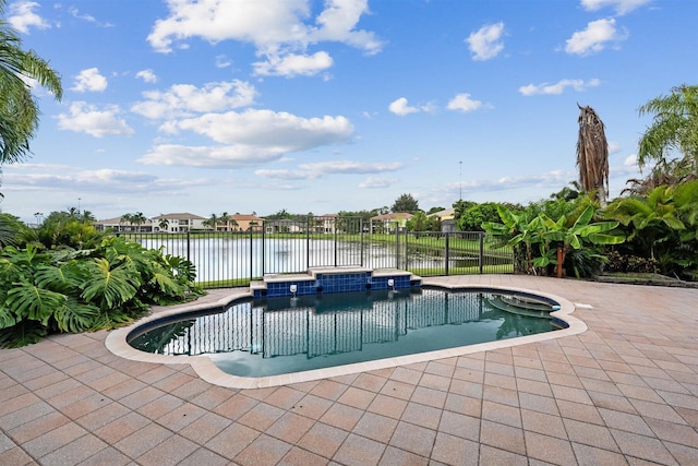 view of swimming pool featuring a patio and a water view