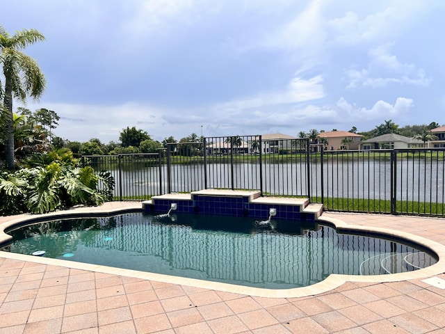 view of swimming pool featuring a water view, pool water feature, and a jacuzzi