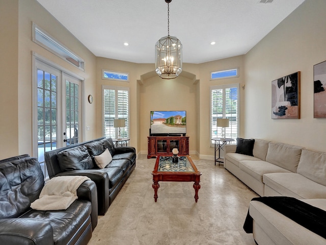 living room with french doors and a chandelier