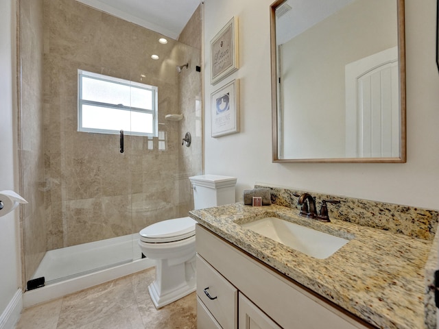 bathroom with a shower with door, vanity, and toilet