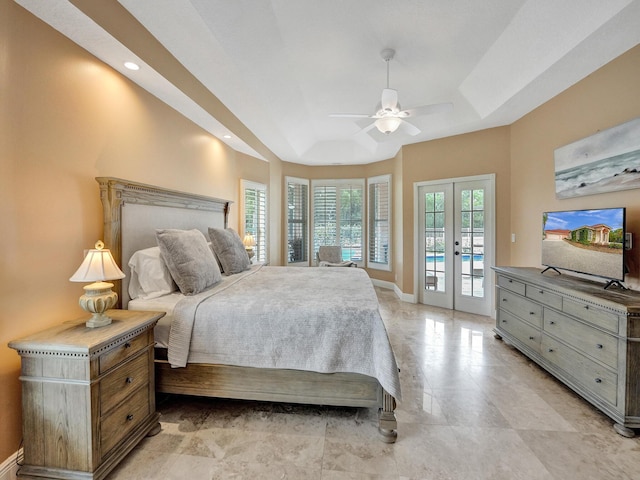 bedroom with a raised ceiling, french doors, access to exterior, and ceiling fan