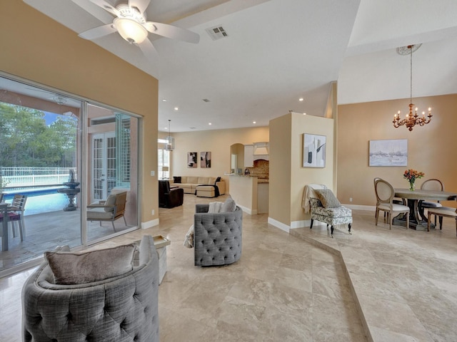 living room featuring ceiling fan with notable chandelier