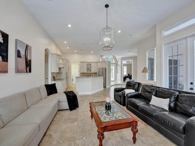 living room featuring sink and a towering ceiling