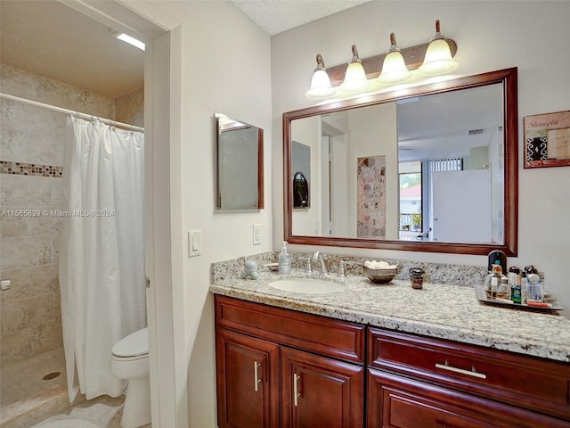 bathroom with vanity, toilet, a textured ceiling, and a shower with curtain