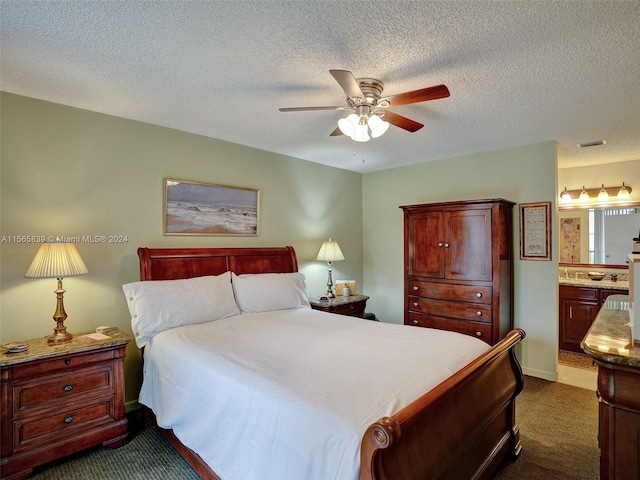 bedroom featuring connected bathroom, ceiling fan, a textured ceiling, and dark carpet