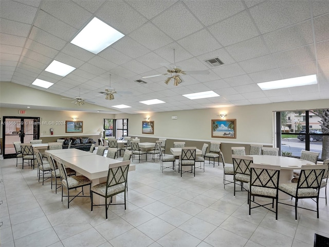 tiled dining area featuring vaulted ceiling and ceiling fan