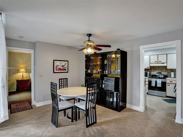 tiled dining area with ceiling fan