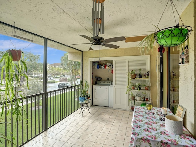 unfurnished sunroom featuring a water view, ceiling fan, and separate washer and dryer