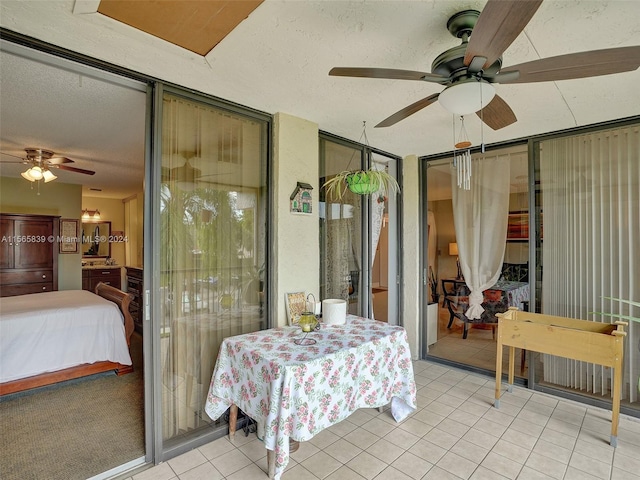 bedroom with ceiling fan, a textured ceiling, and light tile patterned flooring