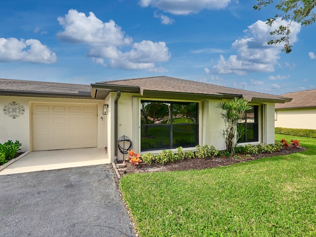 single story home with a garage and a front yard