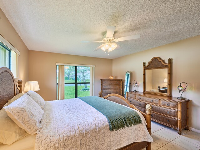 bedroom with a textured ceiling, ceiling fan, and light tile patterned floors