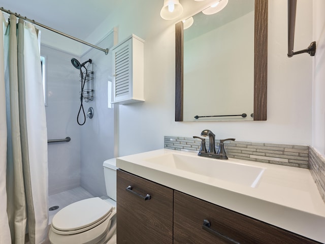 bathroom featuring a shower with curtain, vanity, and toilet