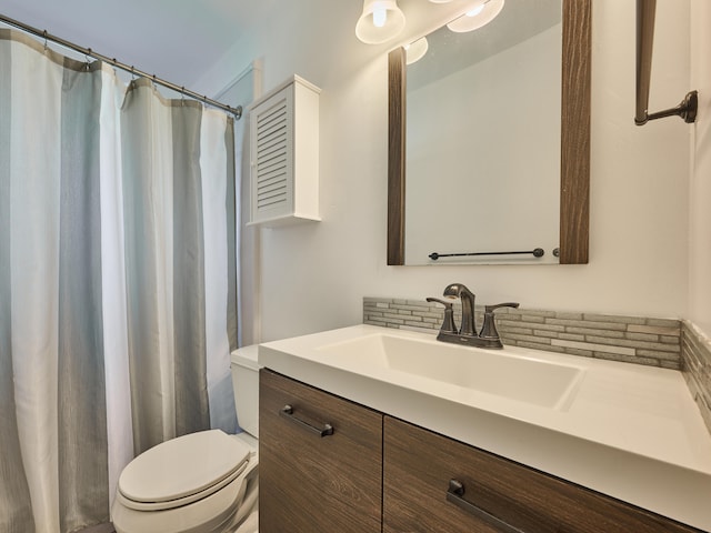 bathroom featuring walk in shower, vanity, and toilet