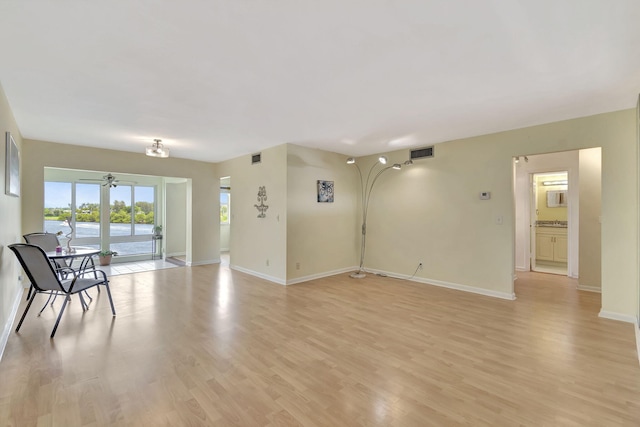 interior space with light wood-type flooring and ceiling fan