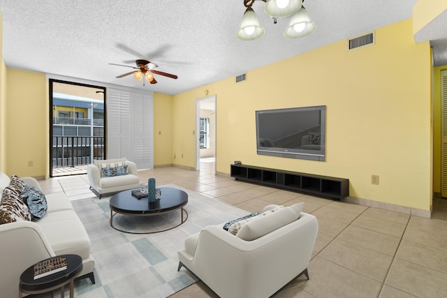 living room with floor to ceiling windows, a textured ceiling, ceiling fan, and light tile patterned floors