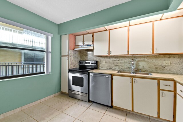 unfurnished room featuring a textured ceiling, ceiling fan, and light tile patterned floors