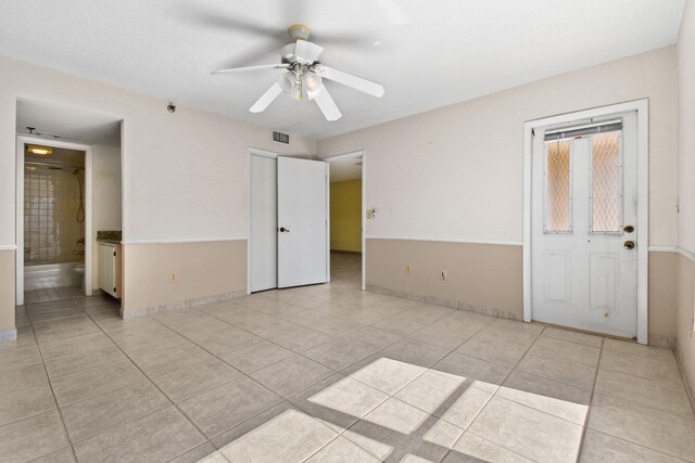 full bathroom featuring tile patterned flooring, tiled shower / bath, toilet, and vanity