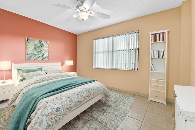 tiled empty room featuring ceiling fan, a textured ceiling, and lofted ceiling