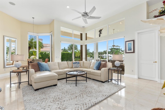 tiled living room featuring a towering ceiling and ceiling fan