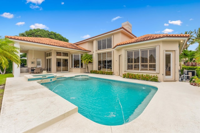 view of swimming pool with an in ground hot tub and a patio