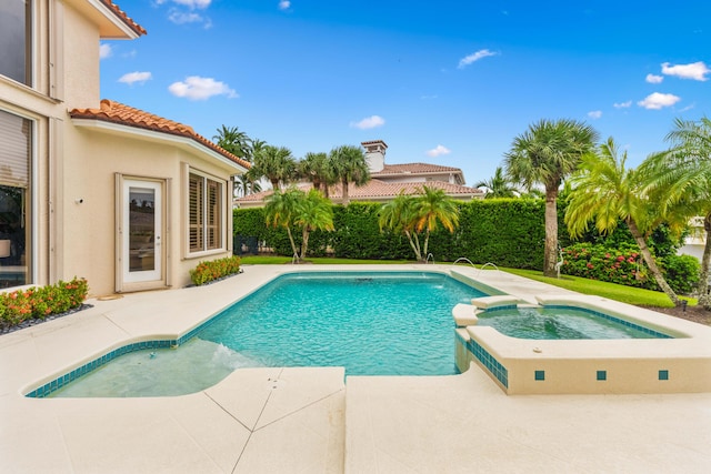 view of pool with an in ground hot tub and a patio