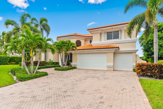 mediterranean / spanish house featuring a garage