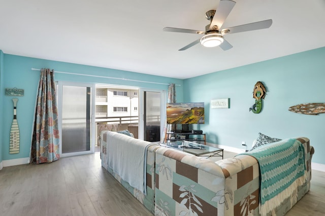 living room with ceiling fan and light hardwood / wood-style flooring