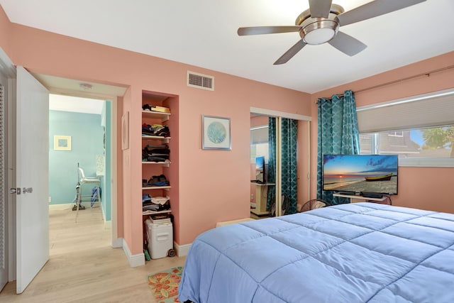 bedroom with ceiling fan, a closet, and light hardwood / wood-style flooring