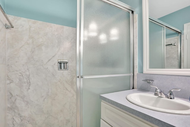 bathroom with walk in shower and vanity