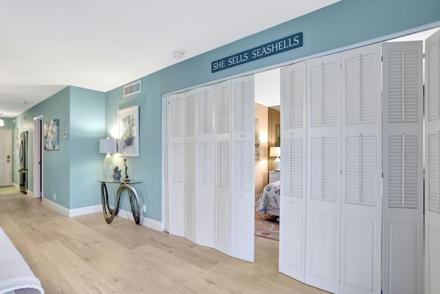 hall with light hardwood / wood-style flooring