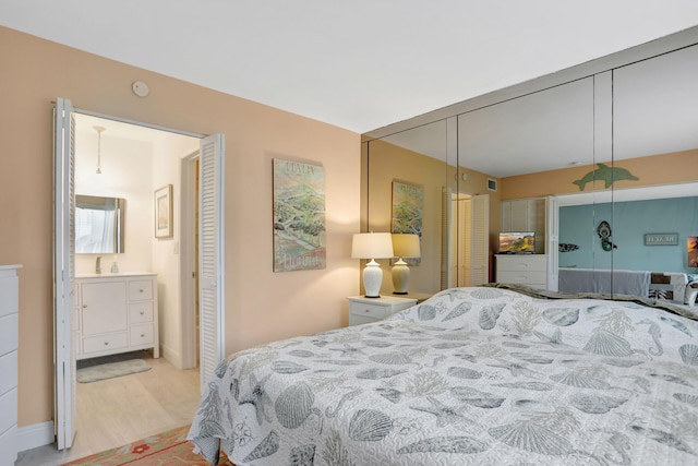 bedroom featuring light hardwood / wood-style flooring and sink