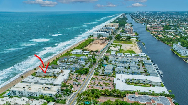 drone / aerial view with a water view and a beach view