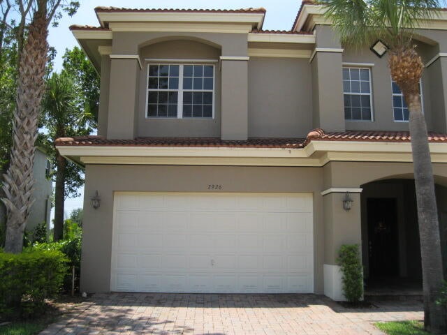 mediterranean / spanish-style home featuring a garage