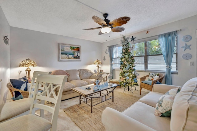 living room with a textured ceiling and ceiling fan