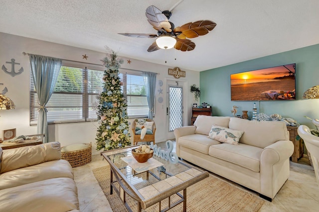 living room with light tile patterned flooring, a textured ceiling, and ceiling fan