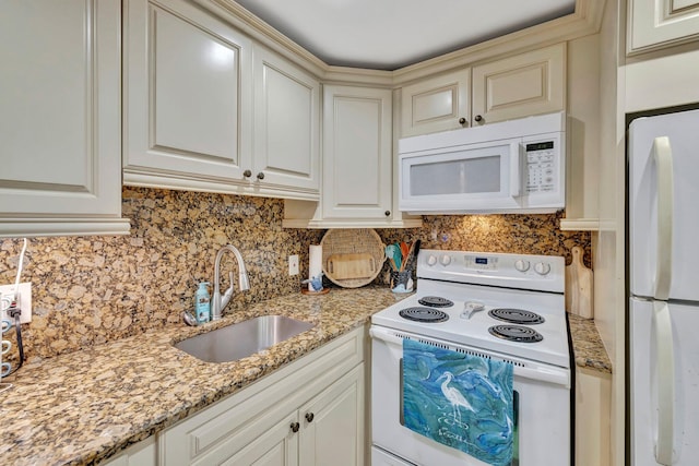 kitchen with sink, light stone countertops, white appliances, and tasteful backsplash