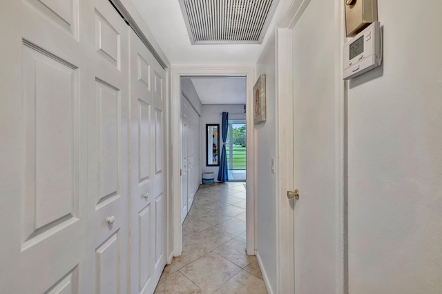 corridor featuring light tile patterned floors