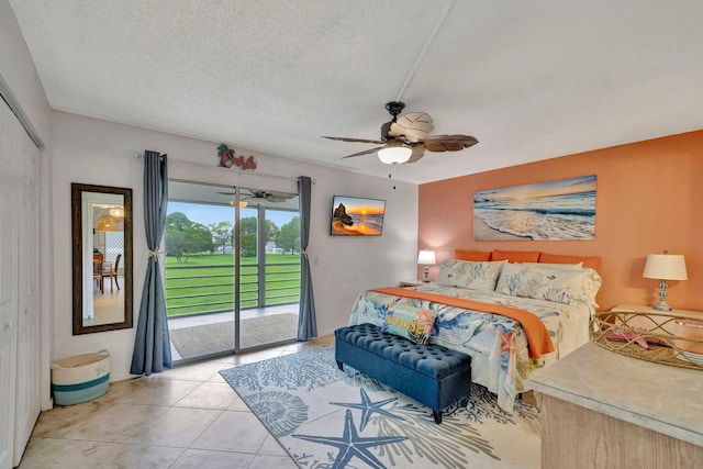 bedroom featuring light tile patterned floors, ceiling fan, access to outside, a textured ceiling, and a closet