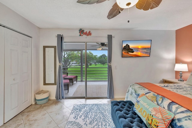 tiled bedroom featuring a closet, ceiling fan, access to outside, and a textured ceiling