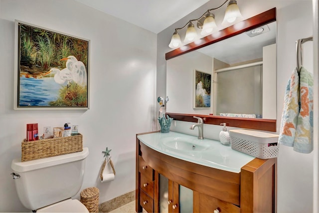 bathroom with vanity, toilet, and an enclosed shower