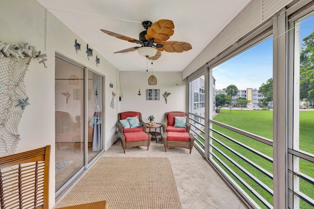 sunroom / solarium featuring ceiling fan