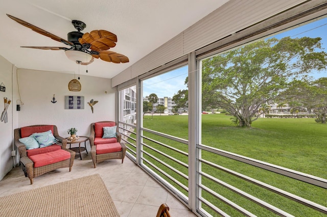 sunroom with lofted ceiling and ceiling fan